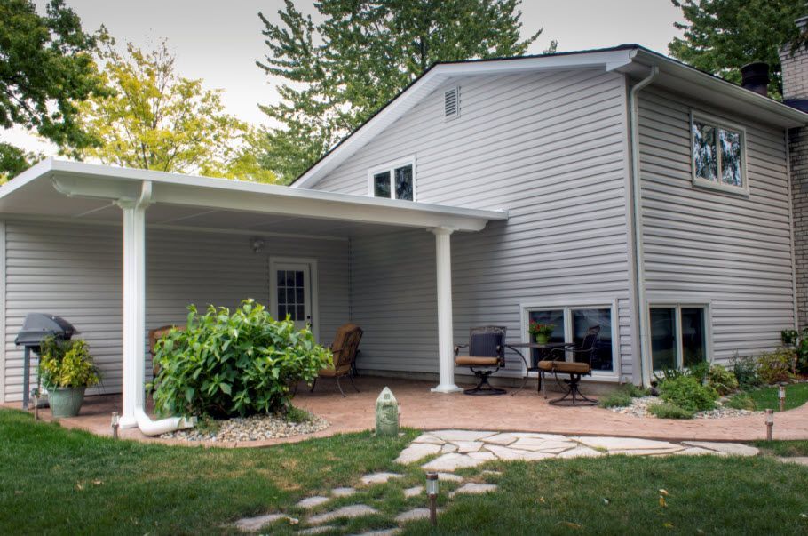 A house with a covered porch and patio area