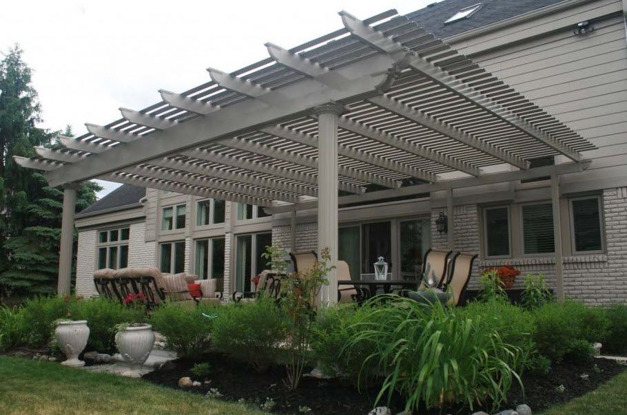 A white house with a pergola on the backyard