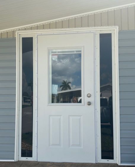 A white door with a window on the side of it