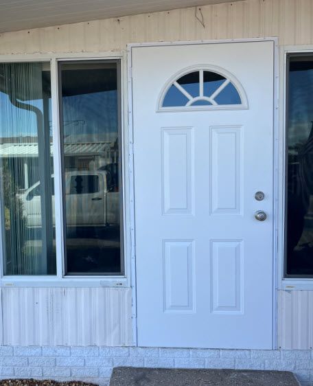 A white door with a window on the side of it