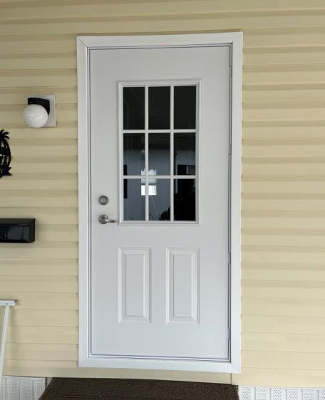 A white door with a window on the side of a house