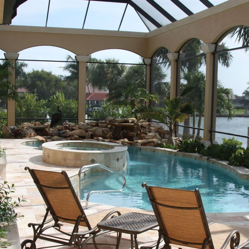 A swimming pool with a hot tub in the background