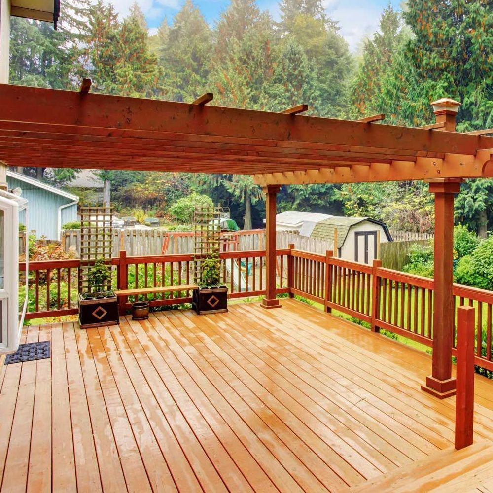 A wooden deck with a pergola over it