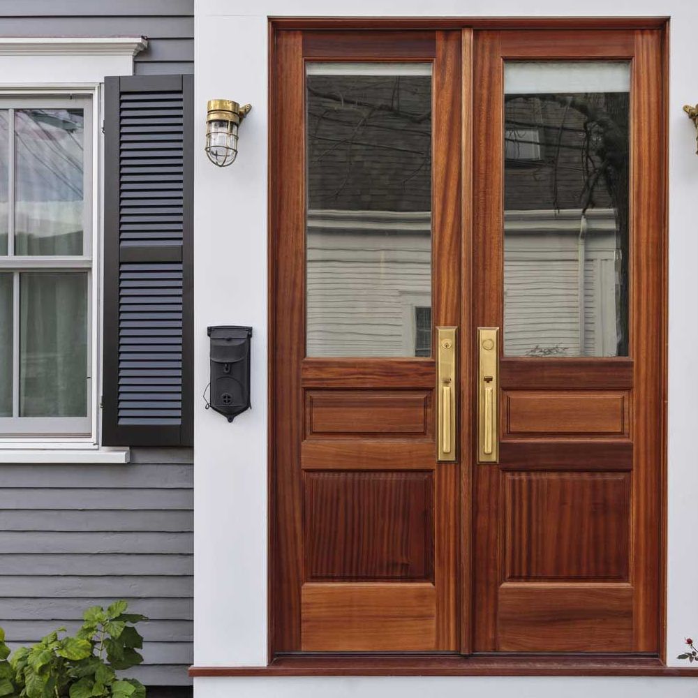 A house with a wooden door and a window with black shutters