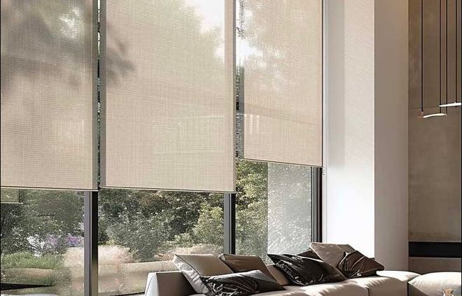 Beige solar shades covering large windows in a modern living room.