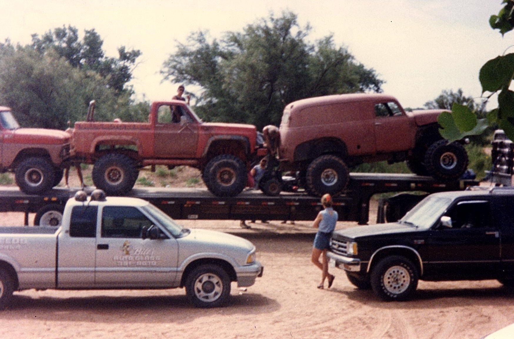 A woman standing next to a truck that says ' sierra ' on it