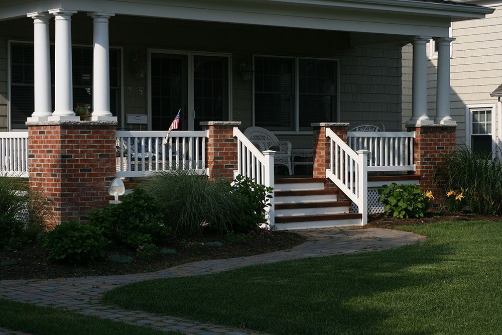 A house with a porch and stairs leading up to it