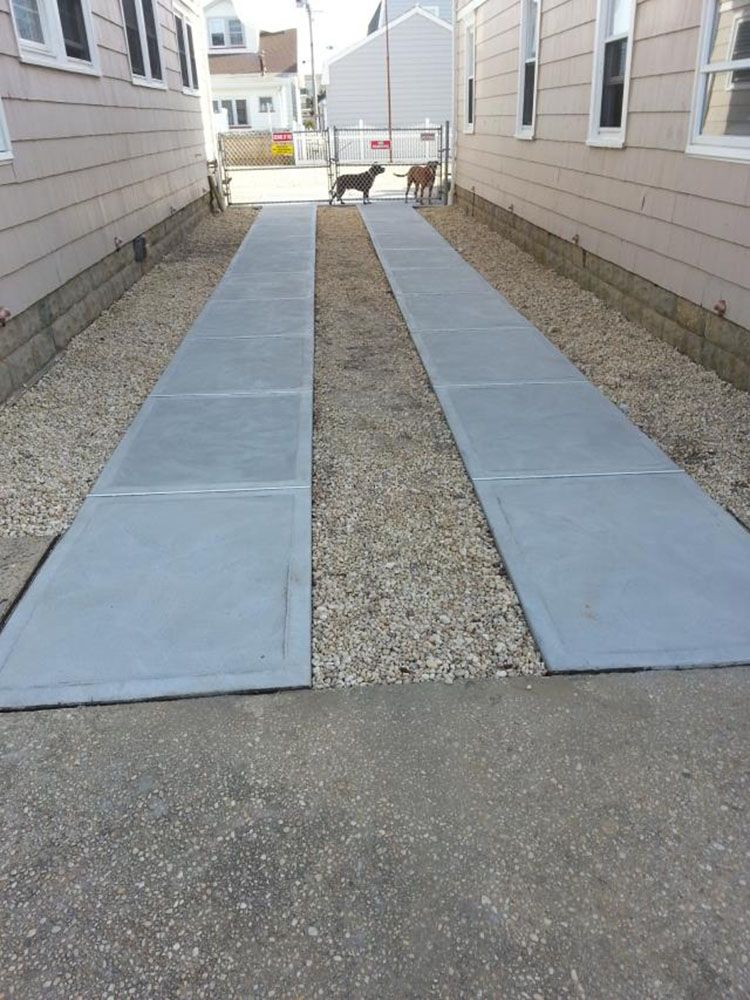 Concrete walkway between two houses