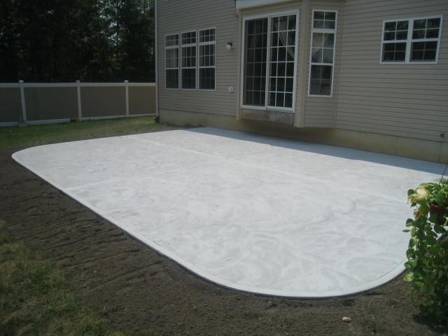A large white concrete patio in front of a house