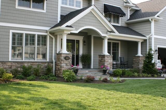 A large house with a lush green lawn in front of it