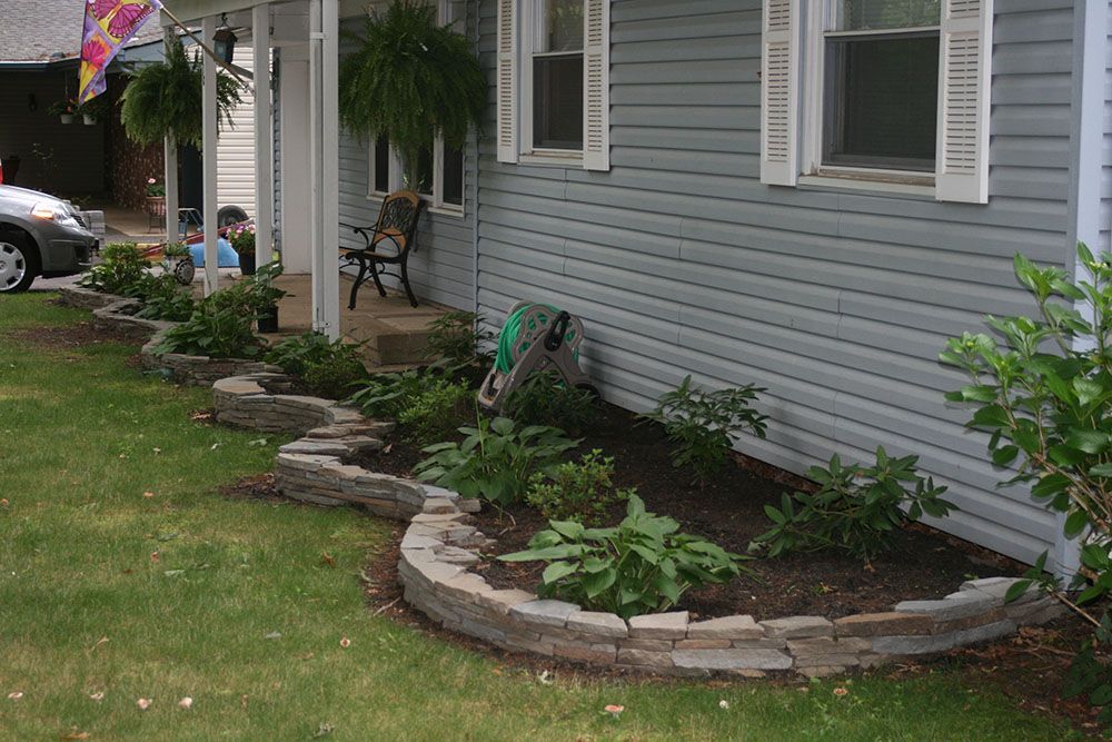 A house with a lot of plants in front of it