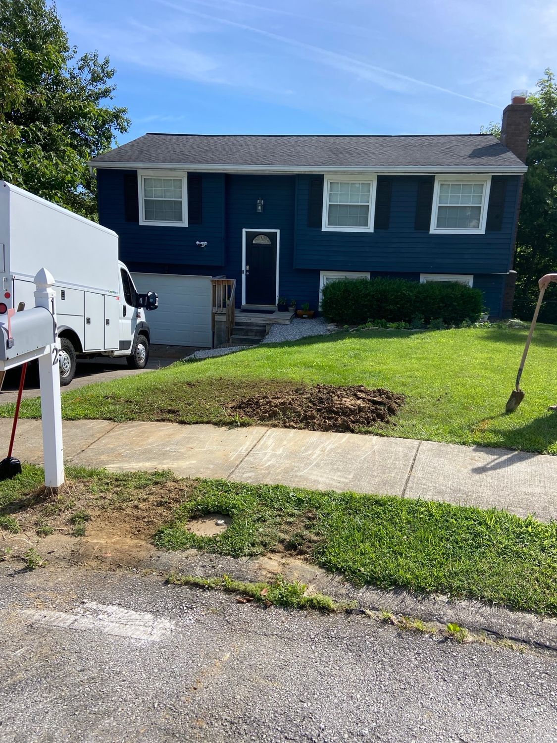 A blue house with a white truck parked in front of it.