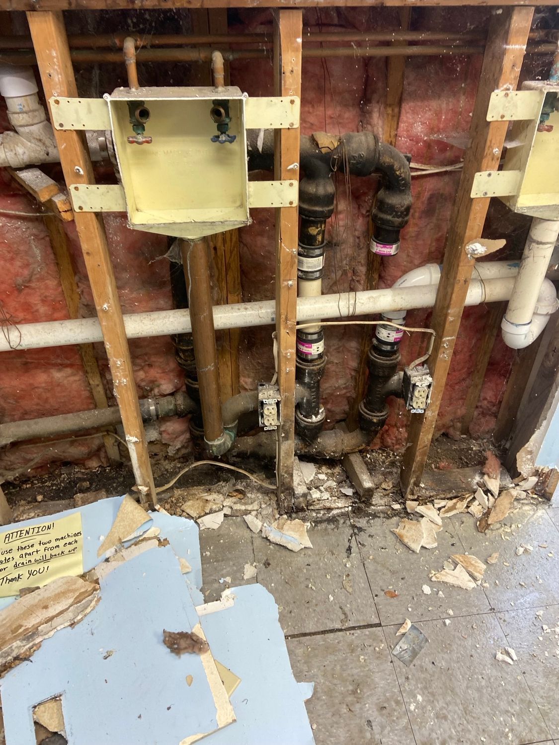 A room with a lot of pipes hanging from the ceiling.