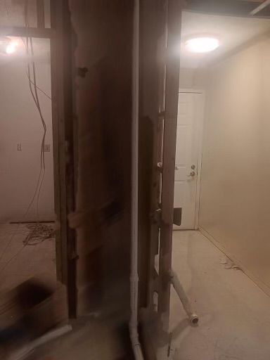 A room with a door and a pipe in it
