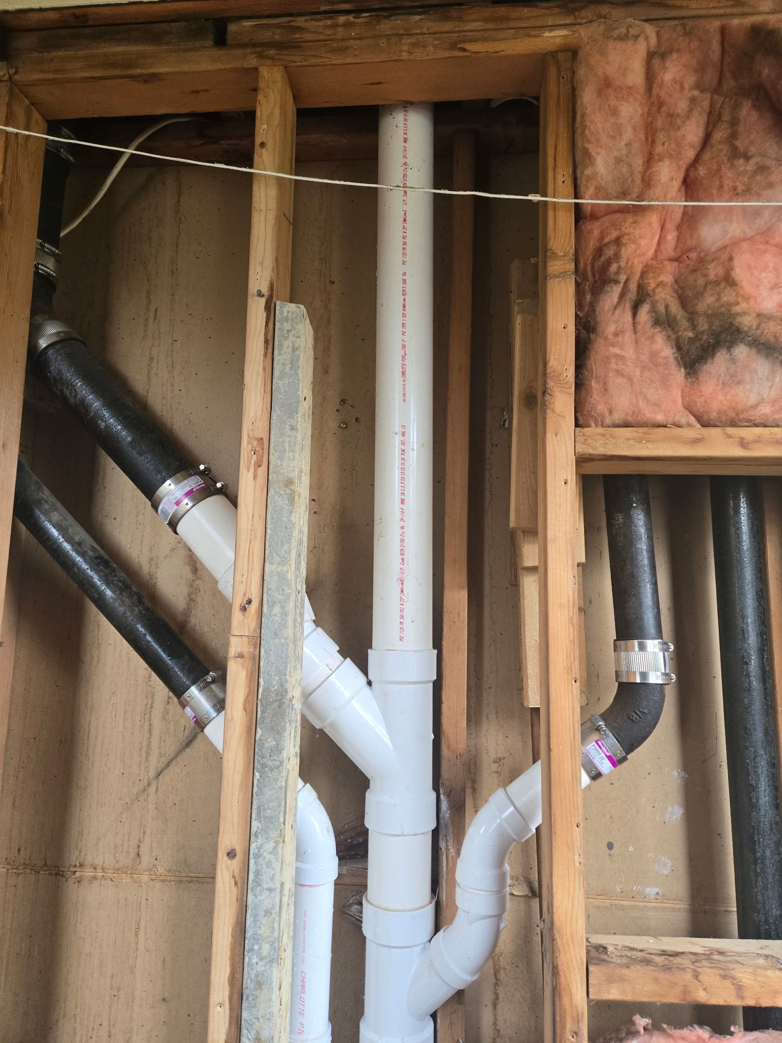 A wall with a bunch of pipes coming out of it