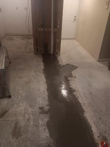 A concrete floor with a hole in it in a room.
