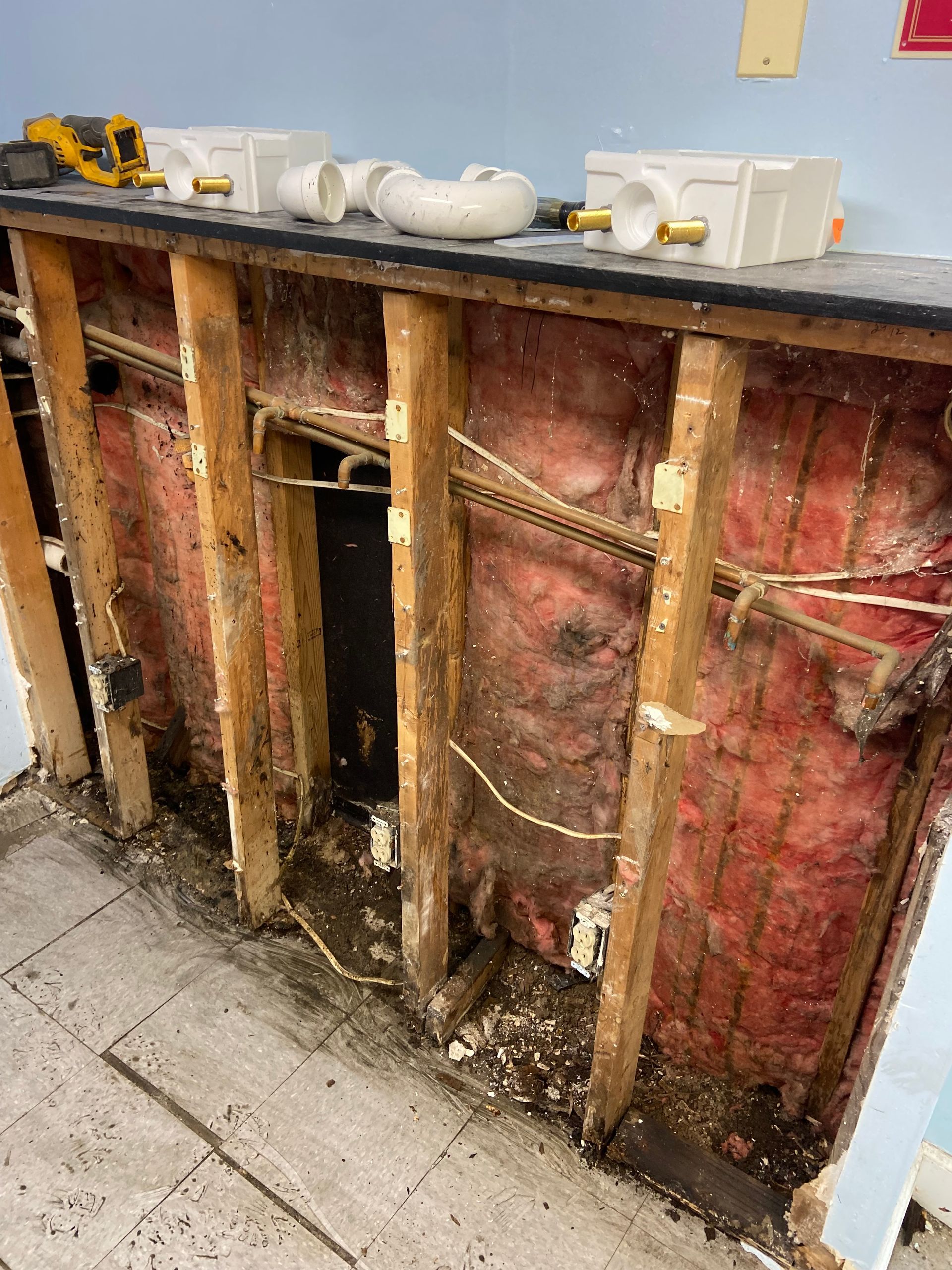 A wall with a lot of wood and insulation is being remodeled.