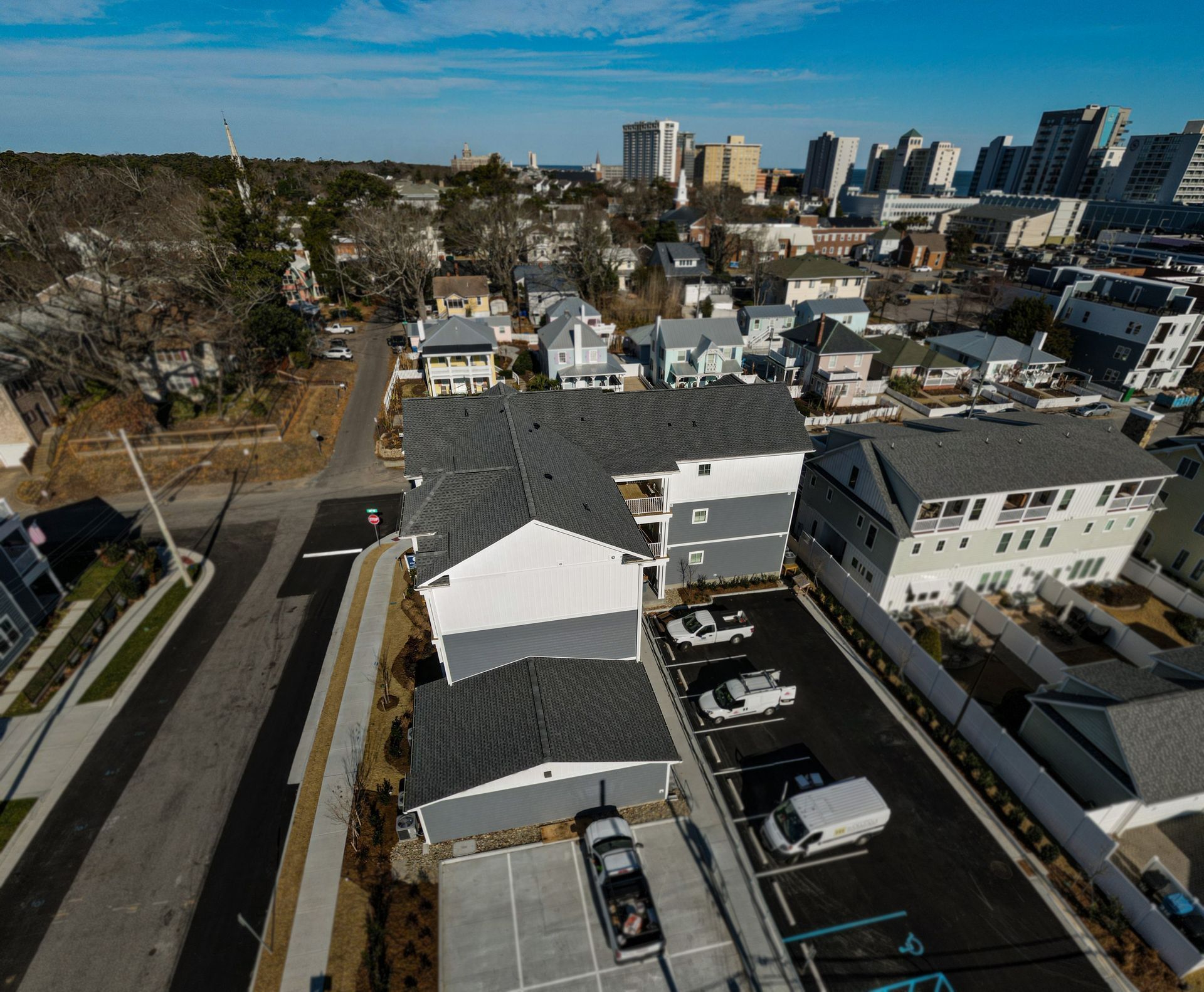 An aerial view of a residential area with cars parked in front of houses