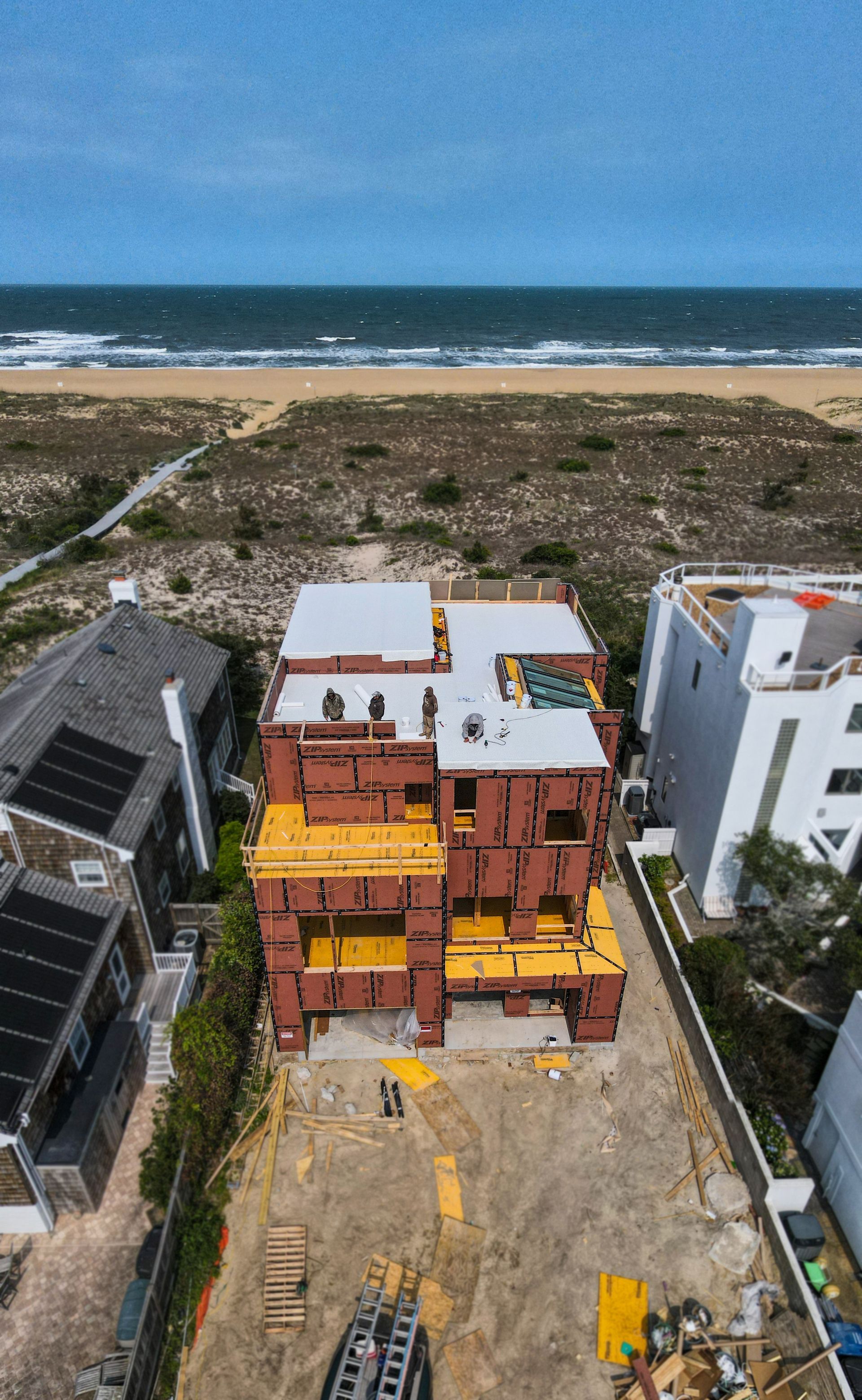 An aerial view of a building under construction next to the ocean.
