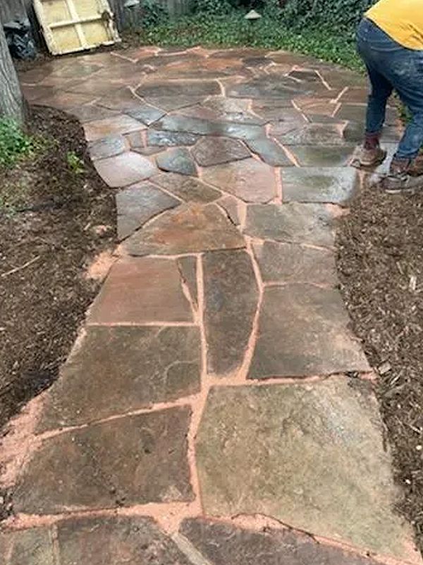 A person is standing on a stone walkway.