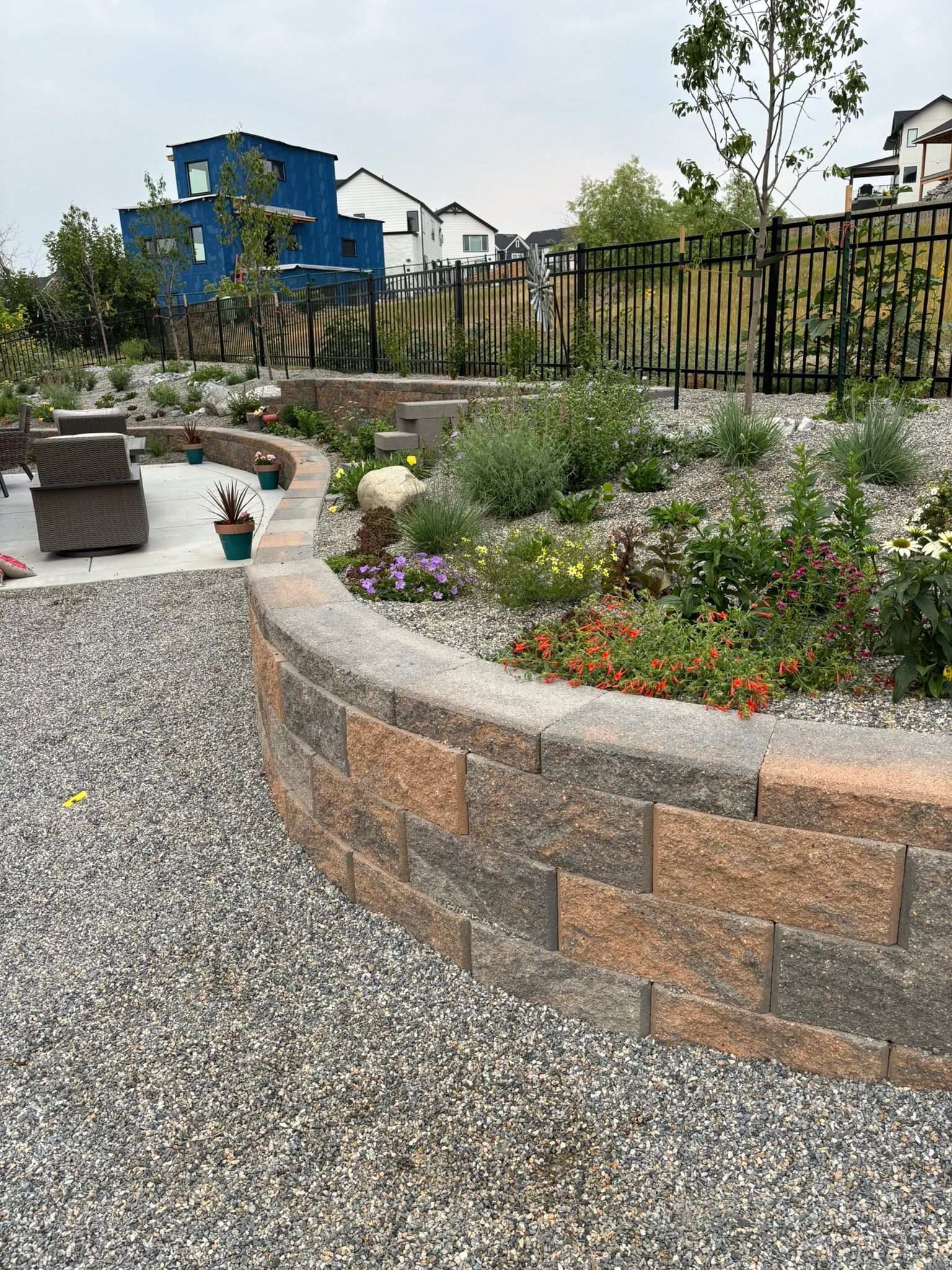 There is a brick wall in the middle of the garden.