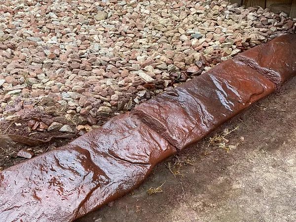 A piece of wood is sitting on top of a pile of gravel.