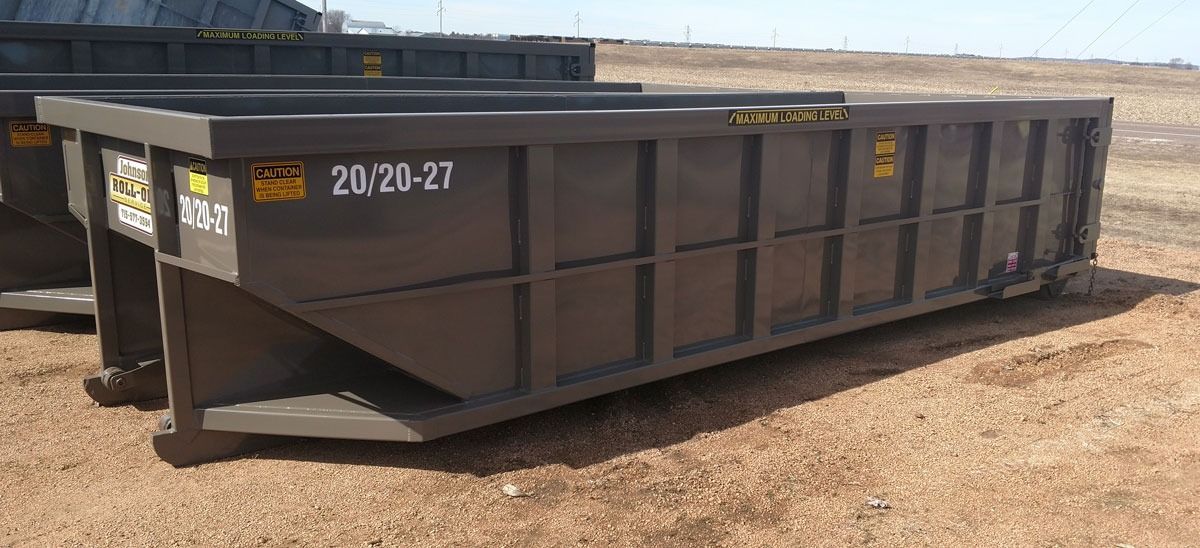 A large, dark gray dumpster with the number 