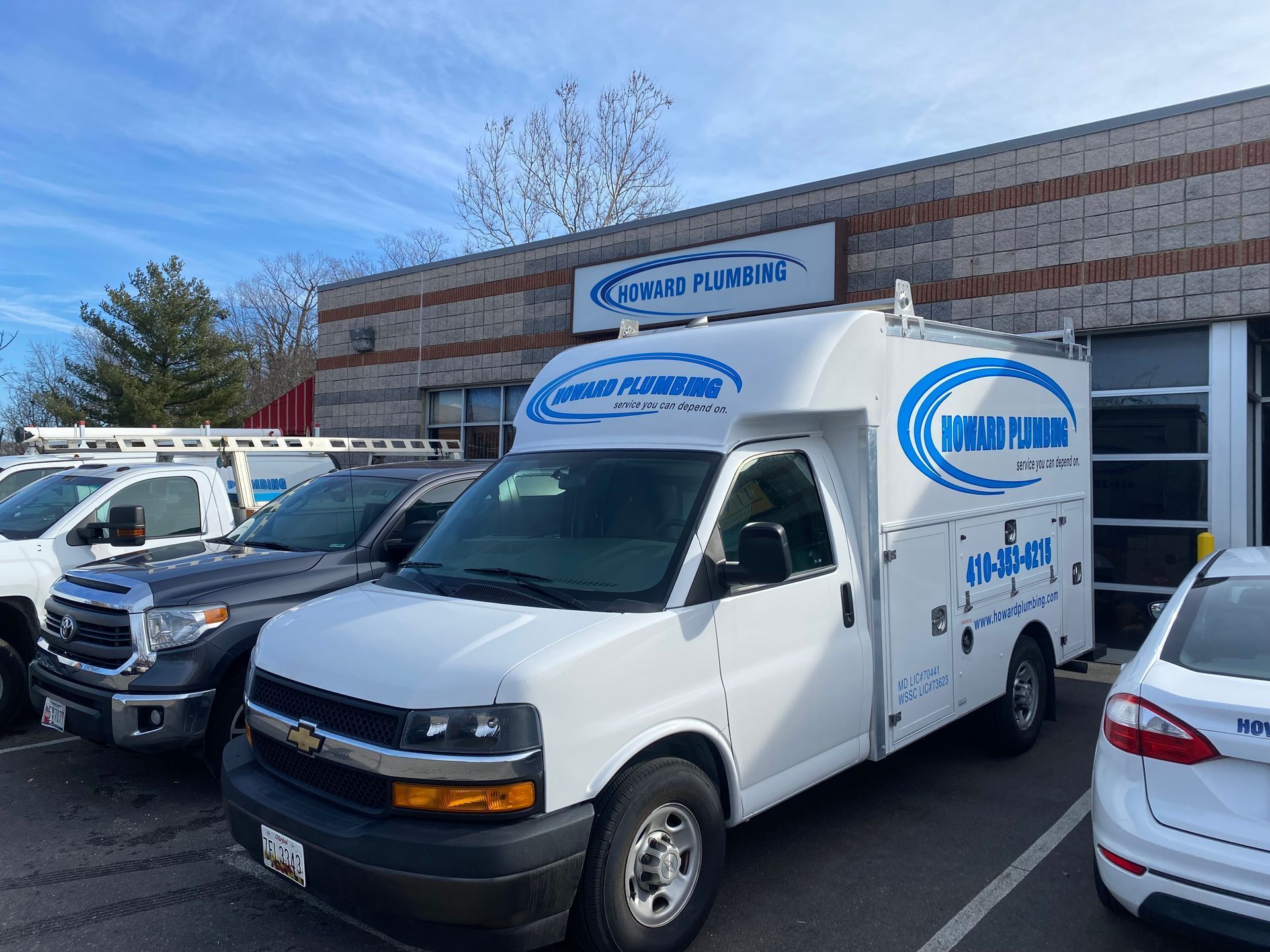 A white work van labeled 