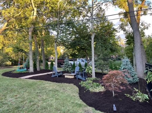 After  - A newly finished landscaping work in a backyard with several trees