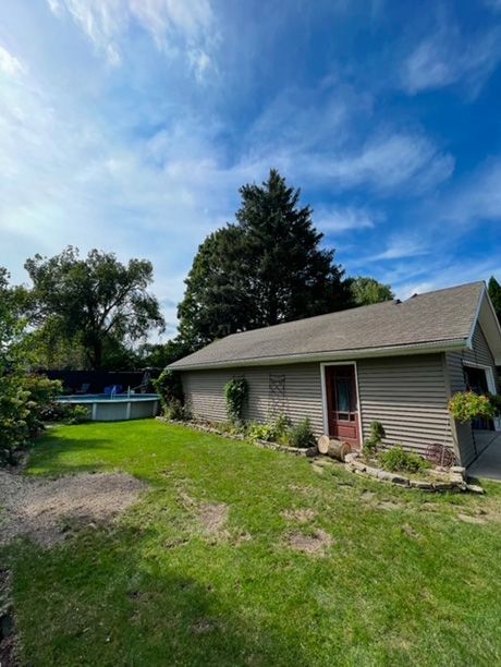 After - The large tree was removed in the backyard of a house