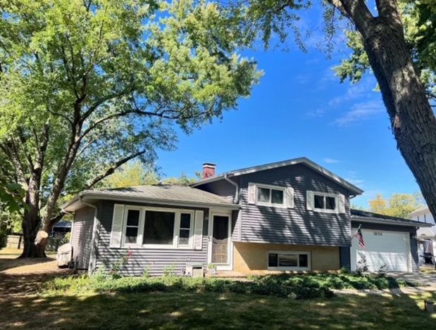 After - Trimmed trees next to a house