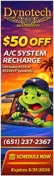 A Dynotech Automotive ad offering $50 off an A/C recharge, featuring a sweating turtle driving a car at sunset.