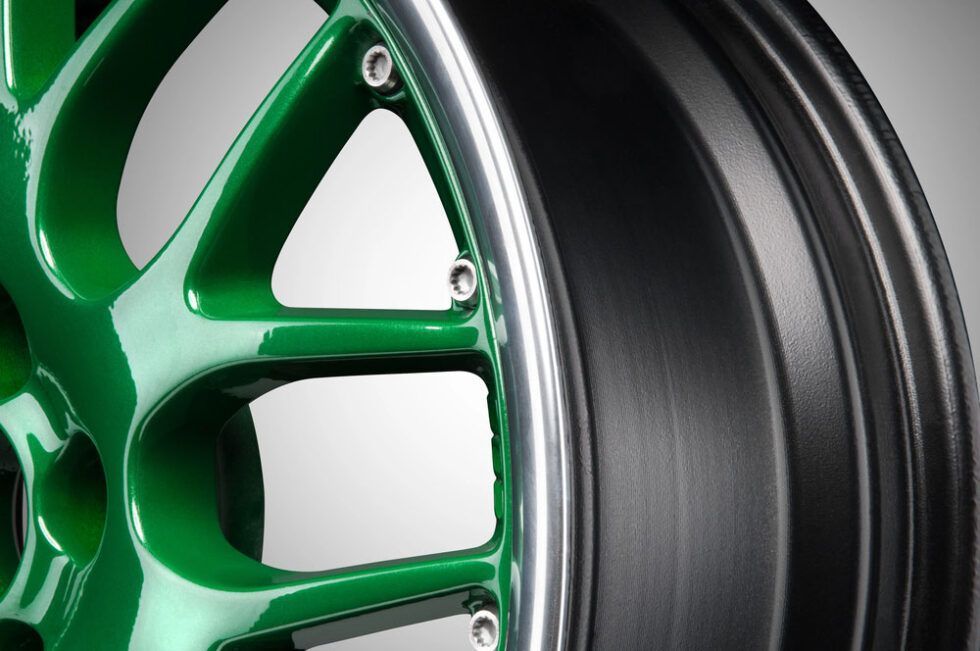 Close-up of a green and black alloy car wheel rim