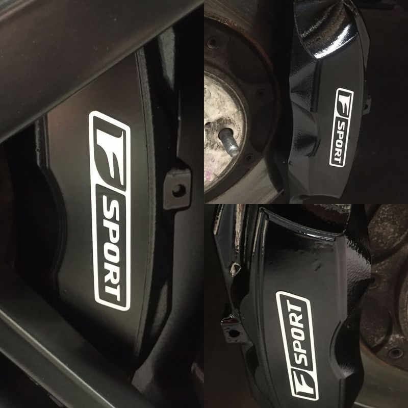 Close-up of black wheel brake calipers with white “F SPORT” logos.