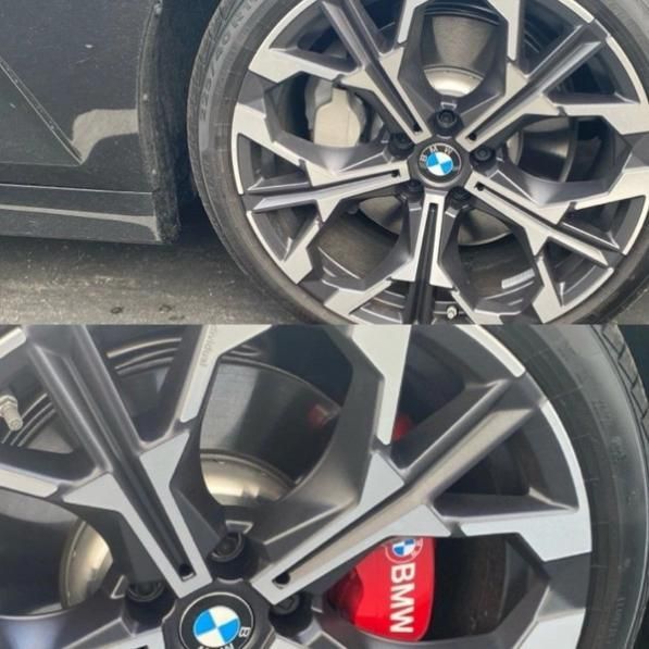 BMW car wheel with silver alloy rim and red brake caliper close-up