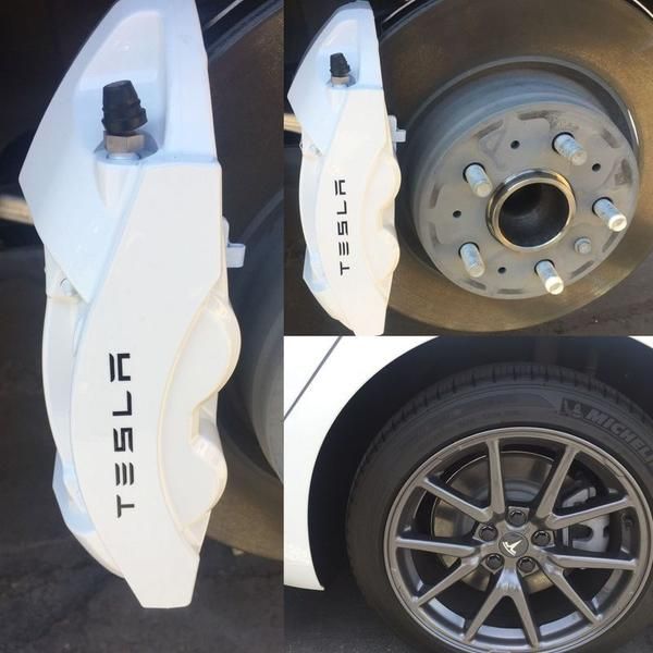 White Tesla brake caliper and wheel close-ups on a car, showing the rim and lug nuts