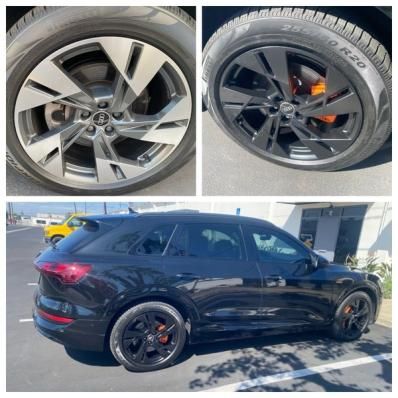 Black SUV with black alloy wheels and orange brake calipers, shown in side profile with close-up wheel details