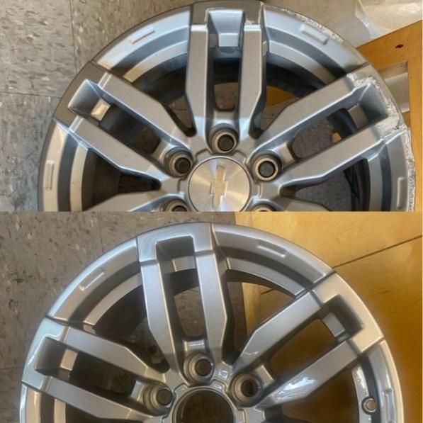 Two silver alloy car wheels with dark gray accents, stacked side by side in a close-up view