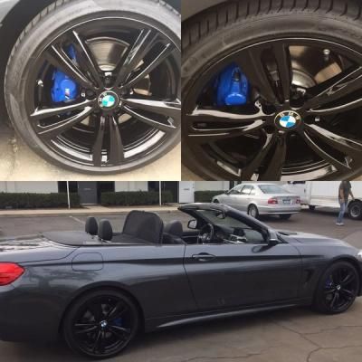 Gray BMW convertible with black rims and blue brakes, shown in side view with a close-up of the wheels above.