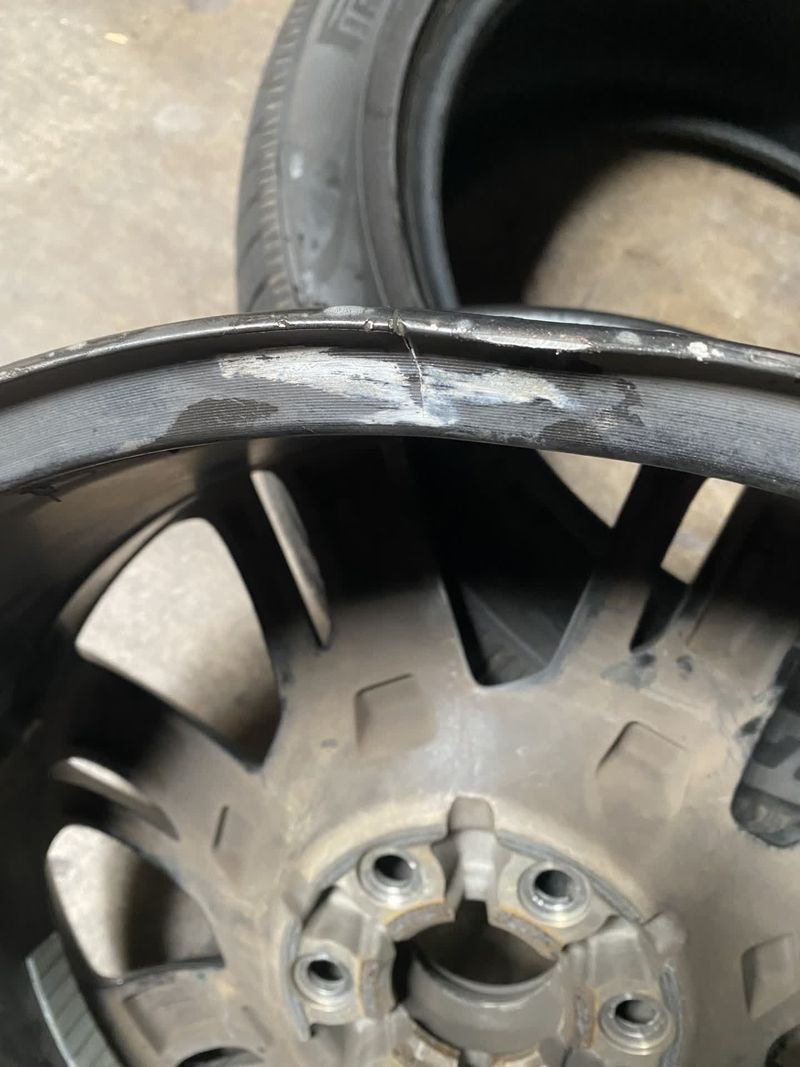 Damaged car wheel rim with cracked tire sidewall in a close-up view