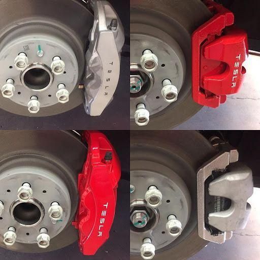 Close-up of four car wheel hubs with different brake calipers in gray, red, and silver.