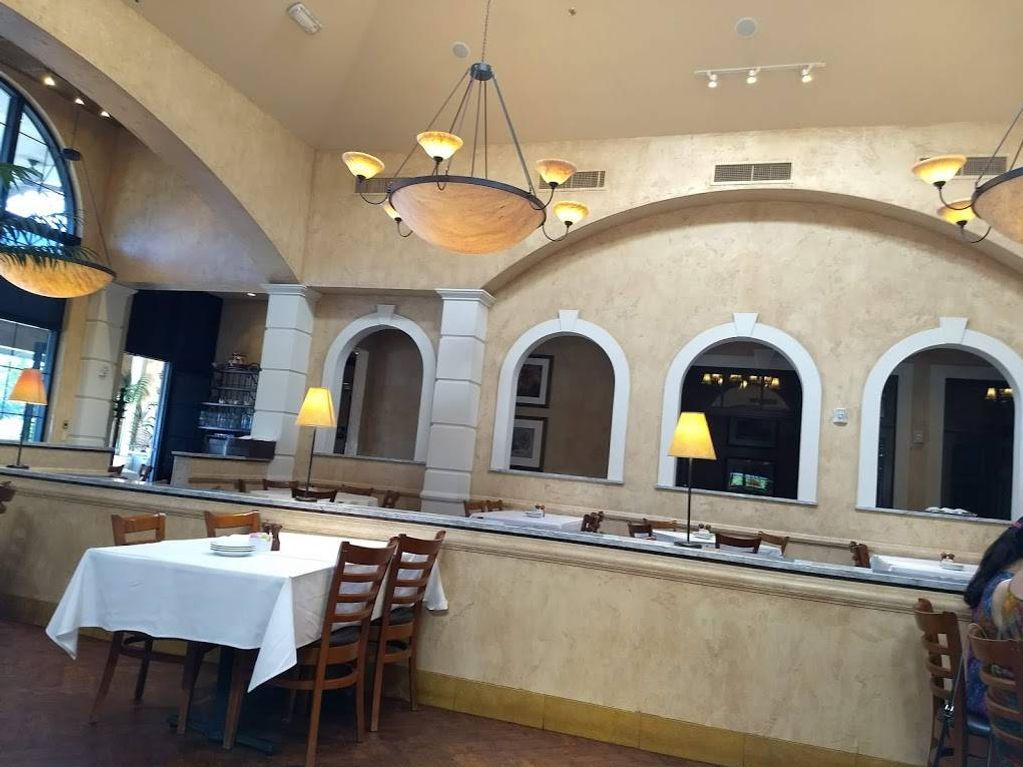 The inside of a restaurant with tables and chairs
