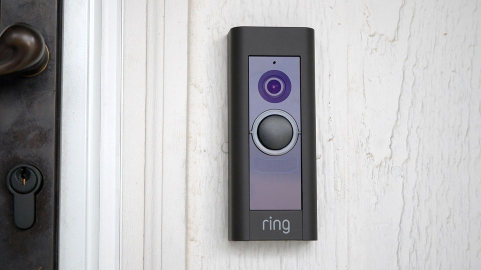 A ring doorbell is mounted on the side of a door.