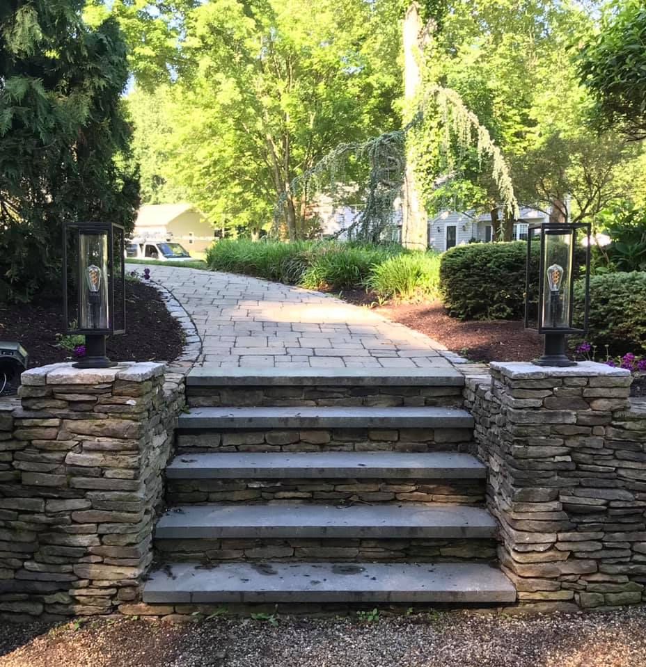 A stone walkway with stairs leading up to a house