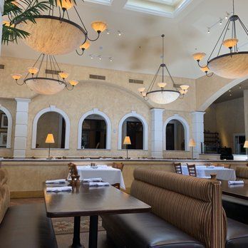 A large house with a porch is lit up at night