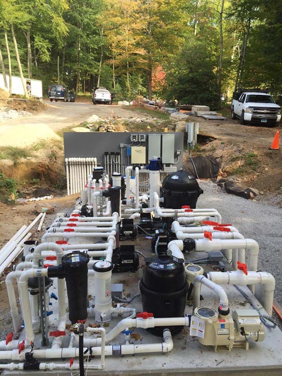 A bunch of pipes are sitting on top of a concrete platform.