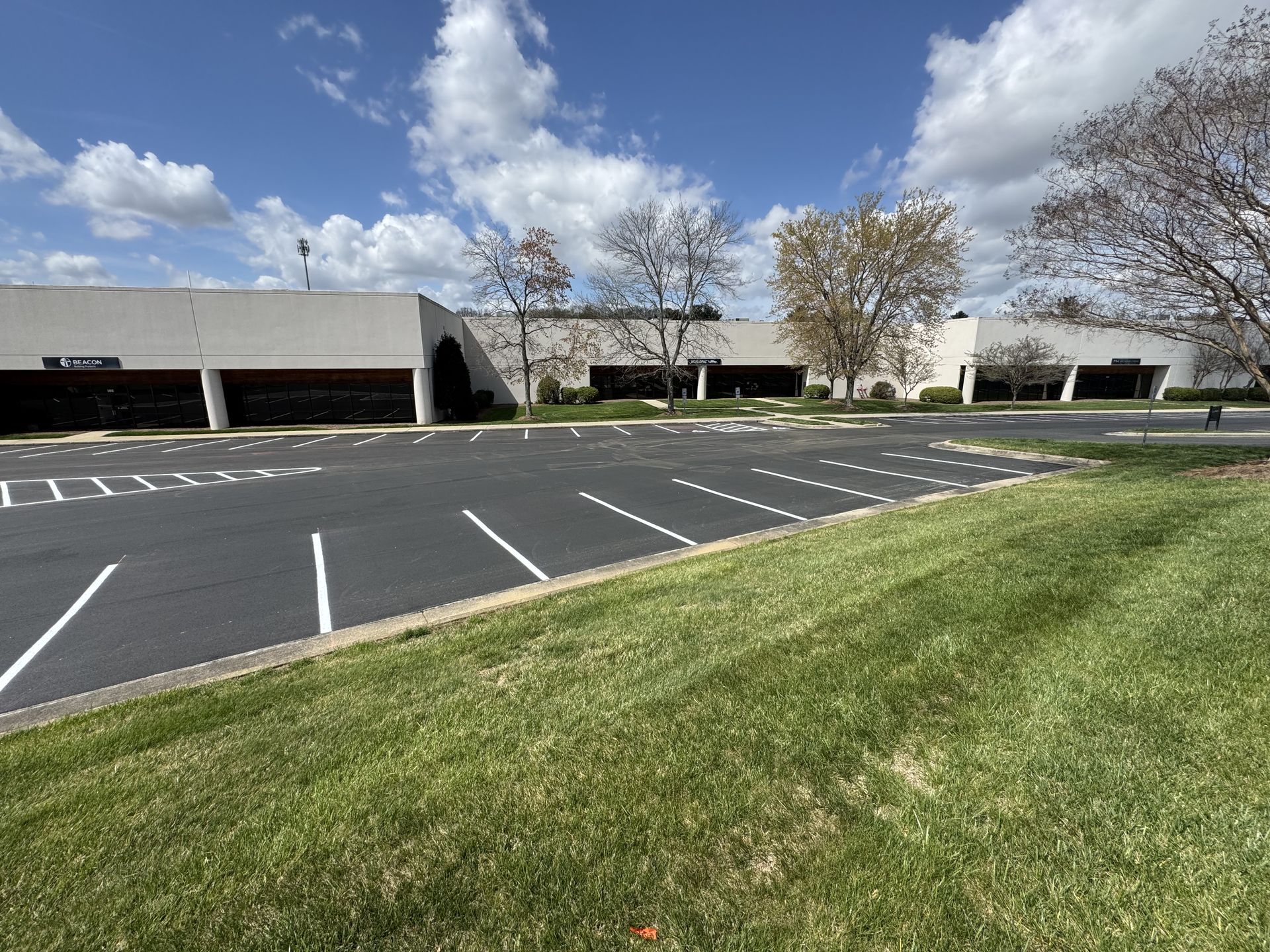 A large building with a parking lot in front of it.