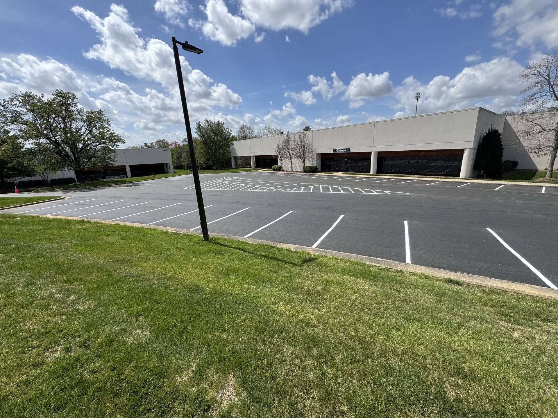 A large building with a parking lot in front of it.