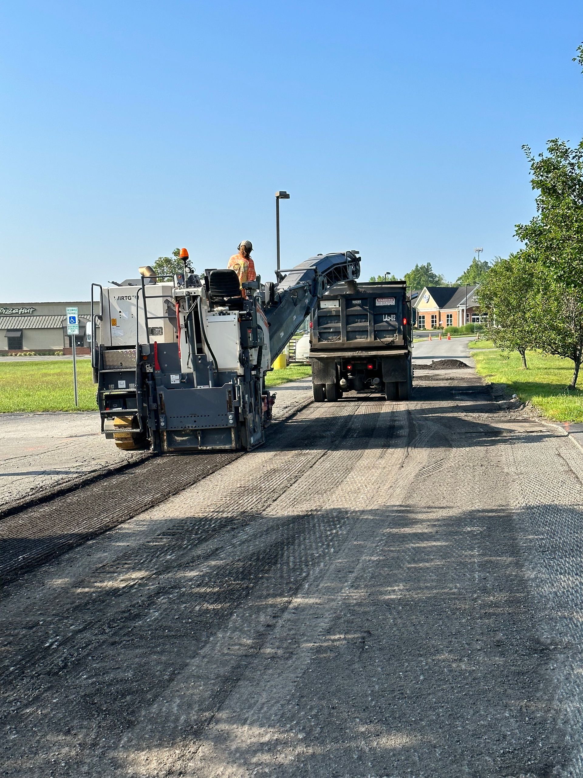 a machine is cutting asphalt on a road