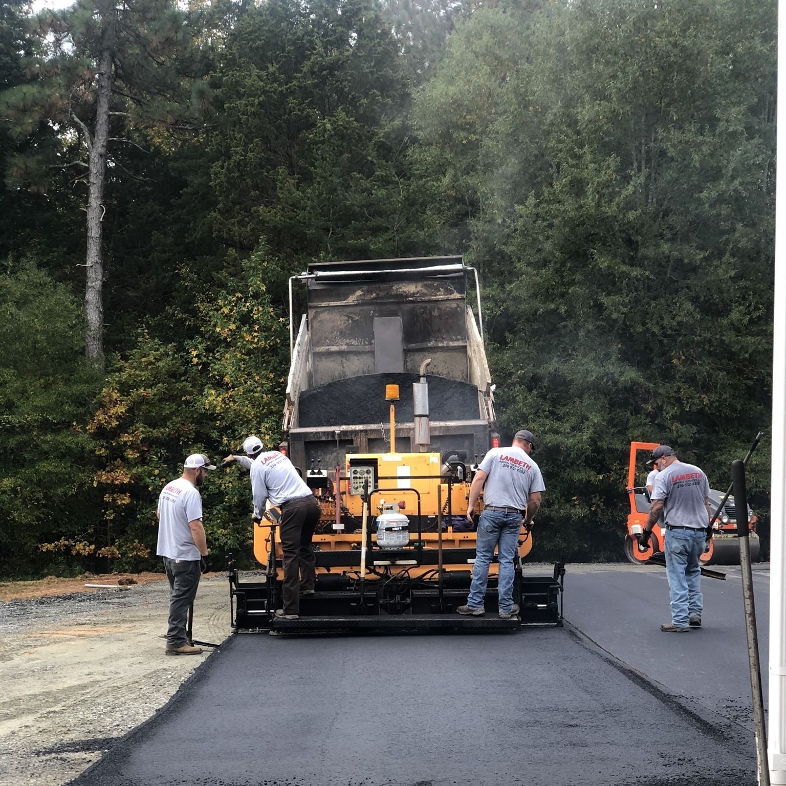 a group of men are working on a road